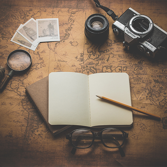 flat ray photography of book, pencil, camera, and with lens, Photo by Dariusz Sankowski on Unsplash